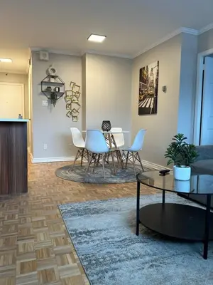 a living room with a table and chairs at Hello,CRESCENT in Montréal