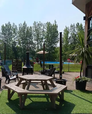 a picnic table and chairs in a park at Loft in Louiseville