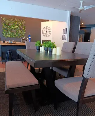 a dining room table and chairs with plants on it at Loft in Louiseville