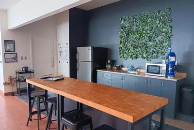 a kitchen with a wooden counter top and a refrigerator at Loft in Louiseville