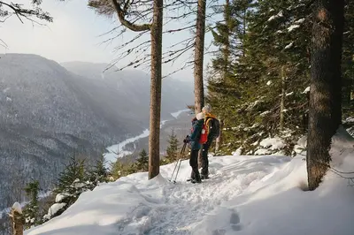 a man standing on top of a snow covered mountain at Mont Megantic - Chalet Le Madison in La Patrie