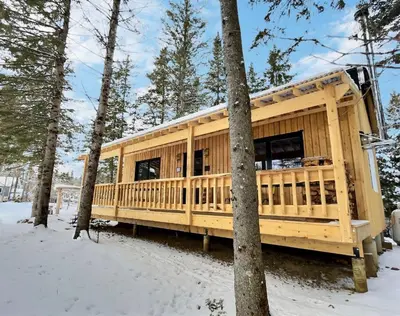 a wooden house in the woods in the snow at Mont Megantic - Chalet Le Madison in La Patrie