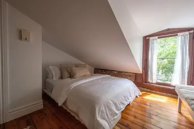 a bedroom with a white bed and a window at Exclusive 6 bed, 6 bath residence in Old Montreal in Montréal