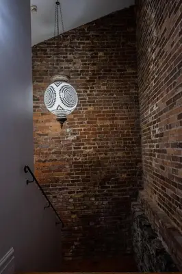 a brick wall with a light attached to it at Exclusive 6 bed, 6 bath residence in Old Montreal in Montréal