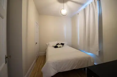 a small bedroom with a bed with a pillow on it at Pignon sur Parc in Trois-Rivières