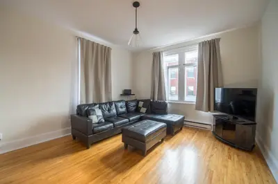 a living room with a couch and a flat screen tv at Pignon sur Parc in Trois-Rivières