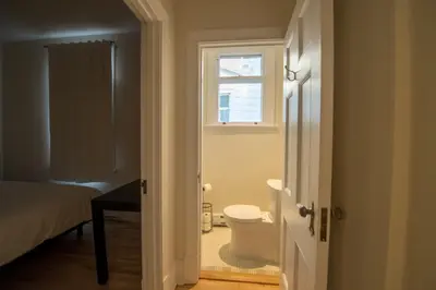 a bathroom with a toilet and a window at Pignon sur Parc in Trois-Rivières