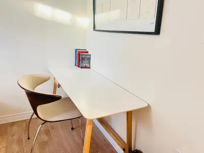 a white table with two chairs and a book on it at Basement 2-bedroom apartment near National Park and Montréal in Saint-Bruno-de-Montarville