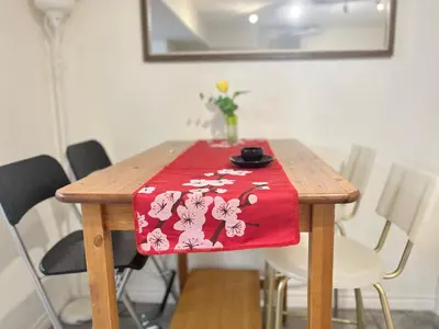 a wooden table with a red table cloth on it at Basement 2-bedroom apartment near National Park and Montréal in Saint-Bruno-de-Montarville