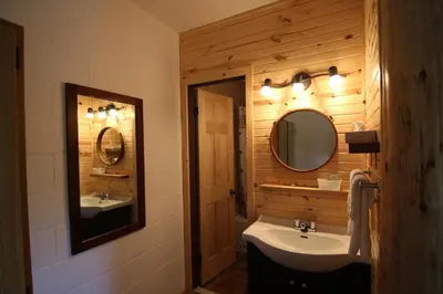 a bathroom with a sink and a mirror at Motel Lennoxville in Sherbrooke