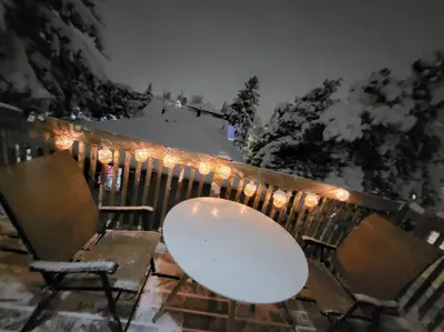 a table and chairs on a fence with lights at Cozy 2BR in VieuxLongueuil +parking 14min Downtown in Longueuil