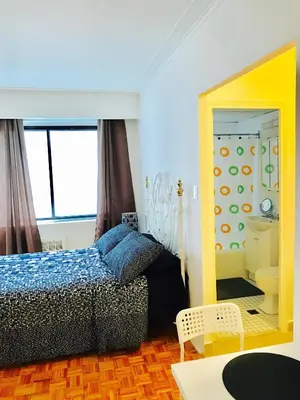 a bedroom with a bed and a bathroom with a mirror at Stylish Montreal Apartment: Comfortable Stay in the Golden Square Mile in Montréal