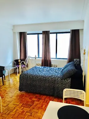 a bedroom with a bed and some windows at Stylish Montreal Apartment: Comfortable Stay in the Golden Square Mile in Montréal
