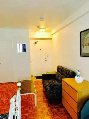 a living room with a couch and a door at Stylish Montreal Apartment: Comfortable Stay in the Golden Square Mile in Montréal