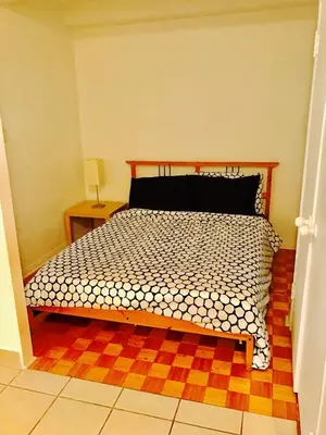 a bedroom with a bed with a black and white comforter at Stylish Montreal Apartment: Comfortable Stay in the Golden Square Mile in Montréal