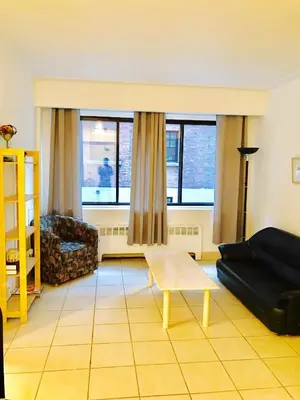 a living room with a couch and a table at Stylish Montreal Apartment: Comfortable Stay in the Golden Square Mile in Montréal