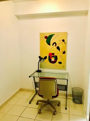 a desk with a chair and a painting on the wall at Stylish Montreal Apartment: Comfortable Stay in the Golden Square Mile in Montréal
