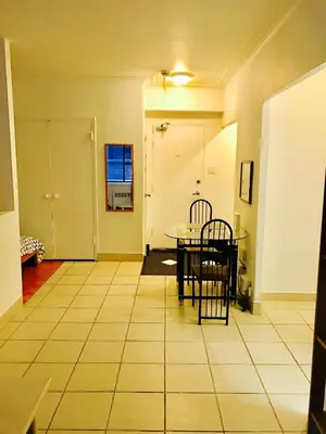 a dining room with a table and chairs in a room at Stylish Montreal Apartment: Comfortable Stay in the Golden Square Mile in Montréal