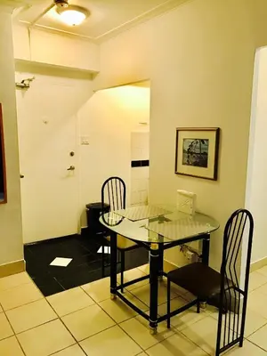 a dining room with a glass table and chairs at Stylish Montreal Apartment: Comfortable Stay in the Golden Square Mile in Montréal