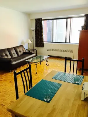 a living room with a table and a couch at Stylish Montreal Apartment: Comfortable Stay in the Golden Square Mile in Montréal