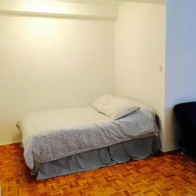 a small bed in a corner of a room at Stylish Montreal Apartment: Comfortable Stay in the Golden Square Mile in Montréal