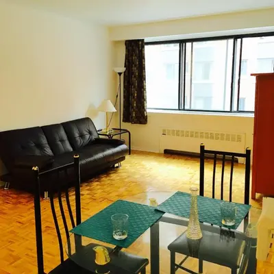 a living room with a couch and a table at Stylish Montreal Apartment: Comfortable Stay in the Golden Square Mile in Montréal