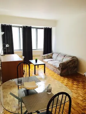 a living room with a couch and a table at Stylish Montreal Apartment: Comfortable Stay in the Golden Square Mile in Montréal