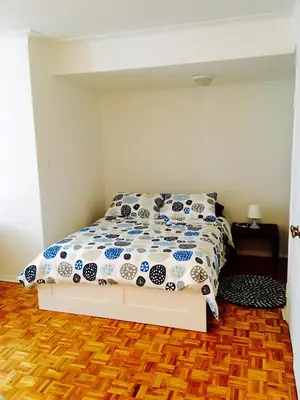 a bedroom with a bed with a blue and white comforter at Stylish Montreal Apartment: Comfortable Stay in the Golden Square Mile in Montréal