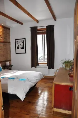 a bedroom with a bed and a window at Le Tierra del Fuego by HomeInMontreal in Montréal