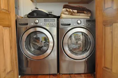 two washing machines sitting next to each other at Le Tierra del Fuego by HomeInMontreal in Montréal