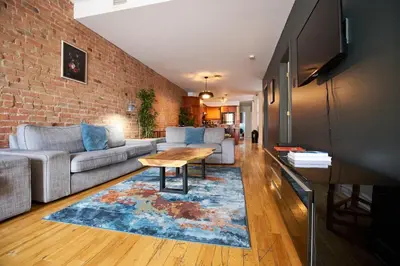a living room with a couch and a table at Le Metro Mont-Royal by HomeInMontreal in Montréal