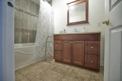 a bathroom with a sink and a tub and a mirror at Le Metro Mont-Royal by HomeInMontreal in Montréal