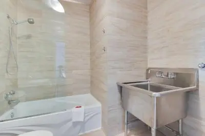 a bathroom with a tub and a sink and a bath tub at Lofts de la petite Italie in Montréal