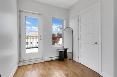 an empty room with a door and a stool at Lofts de la petite Italie in Montréal