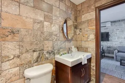 a bathroom with a toilet and a sink and a mirror at Lofts de la petite Italie in Montréal