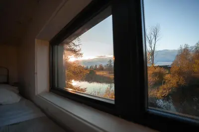 a bedroom window with a view of a lake at MiniBora Le beaumier - Cantons-de-l'Est in Bury