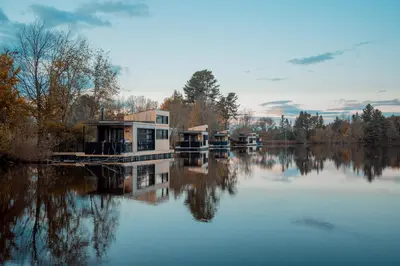 a house on a dock on a body of water at MiniBora Le marin - Cantons-de-l'Est in Bury