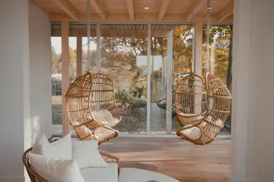 a room with two hanging chairs and a couch at MiniBora Le marin - Cantons-de-l'Est in Bury