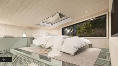 a bedroom with a bed with white sheets and a window at MiniBora Le marin - Cantons-de-l'Est in Bury