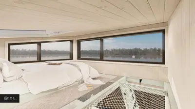 a bed in the center of a room with windows at MiniBora Le ciel - Cantons-de-l'Est in Bury