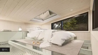 a bedroom with a bed with white sheets and a window at MiniBora Le ciel - Cantons-de-l'Est in Bury