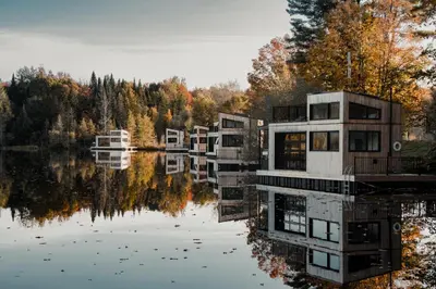 a row of houses sitting on a lake at MiniBora Le moka - Cantons-de-l'Est in Bury