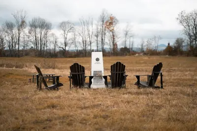 a group of chairs and tables in a field at MiniBora Le cumulus - Cantons-de-l'Est in Bury