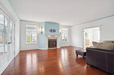a living room with a couch and a fireplace at Private Waterfront Villa 9 BR Peaceful in Laval