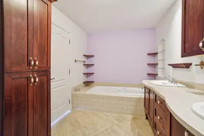 a bathroom with a bath tub and a sink at Private Waterfront Villa 9 BR Peaceful in Laval