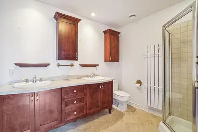 a bathroom with two sinks and a toilet at Private Waterfront Villa 9 BR Peaceful in Laval