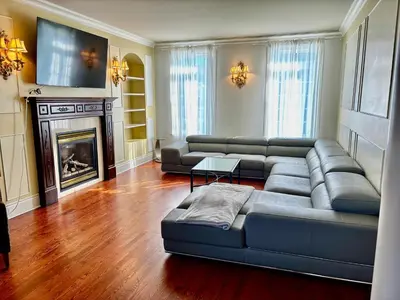 a living room with a couch and a fireplace at Private Waterfront Villa 9 BR Peaceful in Laval