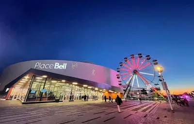 a large building with a ferris wheel in front of it at Private Waterfront Villa 9 BR Peaceful in Laval