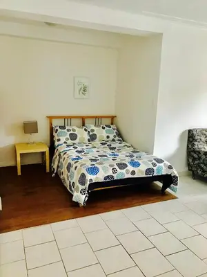 a bedroom with a bed and a table and a chair at Stylish Montreal Apartment: Comfortable Stay in the Golden Square Mile in Montréal