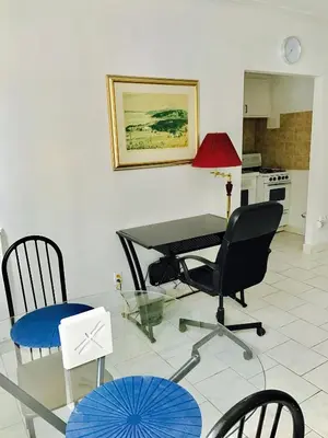 a living room with a glass table and chairs at Stylish Montreal Apartment: Comfortable Stay in the Golden Square Mile in Montréal